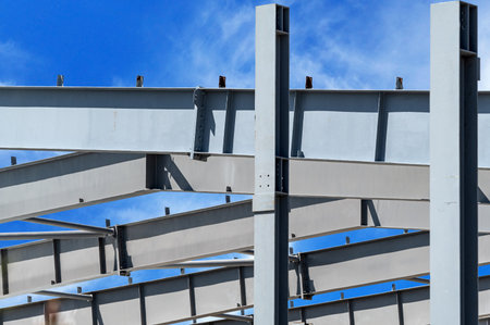 Steel Frames of A Building Under Construction on a background blue skyの写真素材