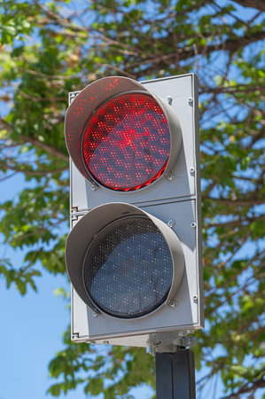 Illuminated red traffic signal light on modern led traffic light