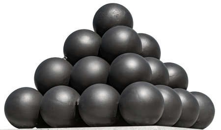 A pyramid of black solid shots on a white backgroundの写真素材