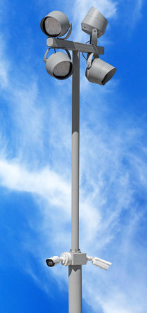 IP security camera and led Street lantern mounted on post against the blue sky