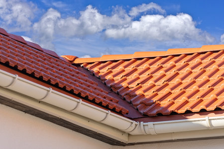 A building with red tiles on a blue sky background