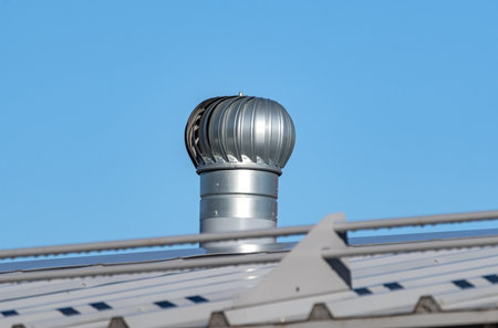 house with metal tile roof on background of blue skyの写真素材
