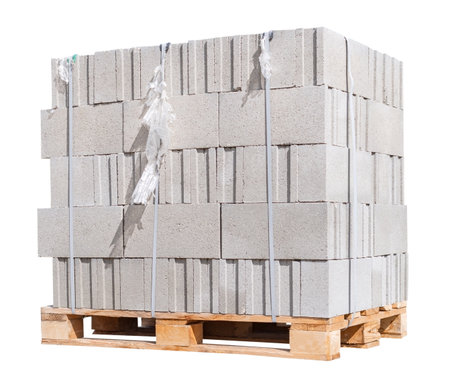 The pallet with a stack of concrete curbstone on white backgroundの写真素材