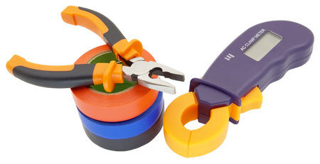 Digital multimeter, pliers and multicolored electrical tape on a white background.の写真素材