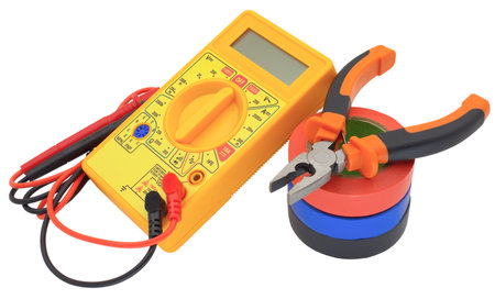 Digital multimeter, pliers and multicolored electrical tape on a white background.
