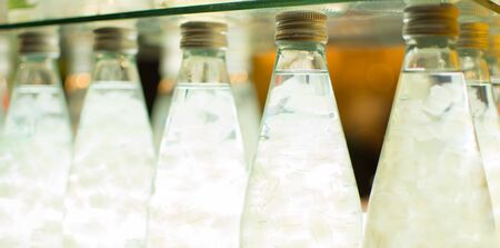 Fresh aloe vera and jelly in Glass bottles placed on a refrigerator.の写真素材