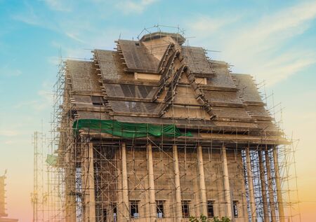 Traditional Thai church is under construction in the temple on sunset background.の写真素材