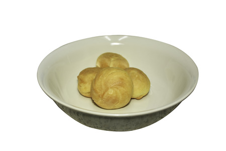 Eclaire cream vanilla on the bowl solated on white background.