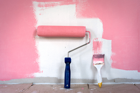 hand painting wall with paint rollerの写真素材