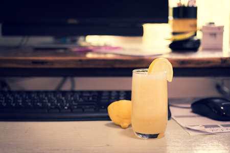 Lemon juice on office desk .no sleepy food fresh vintage styleの写真素材