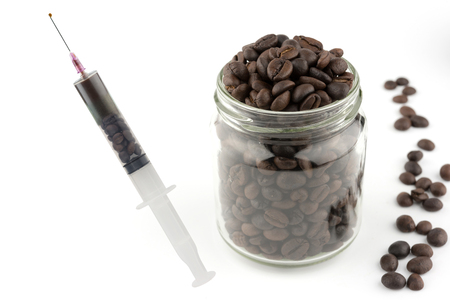 mean to caffeine addiction Syringe full of coffee beans. Coffee addiction conceptの写真素材