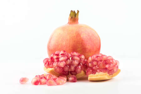 Ripe pomegranates with leaves isolated on a white background.の写真素材