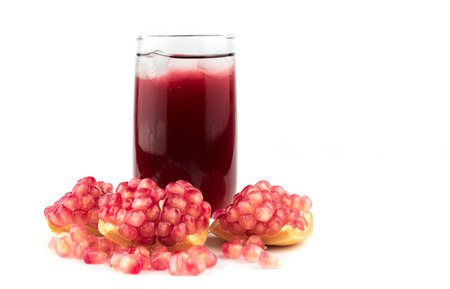 Glass of pomegranate juice with fruit isolated on white.の写真素材