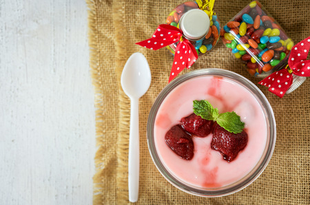 strawberry yogurt with strawberry  on wooden. strawberry yoghurt. pink yogurt. strawberry in strawberry yogurt. heart in yogurt. heart. valentine 's day.の写真素材