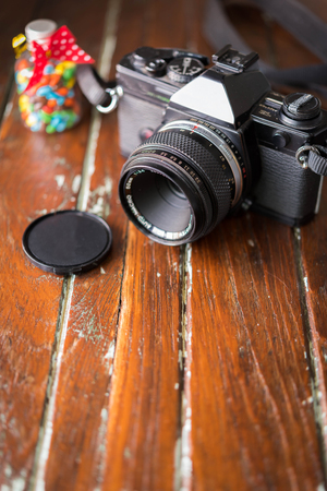 Vintage photo camera on a wooden tableの写真素材