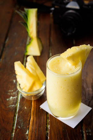 Glass of fresh healthy pineapple smoothie isolated on white backgroundの写真素材