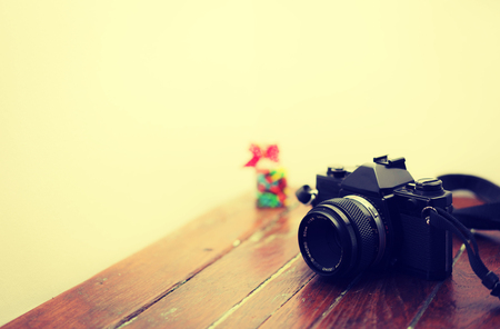 Vintage photo camera on a wooden tableの写真素材