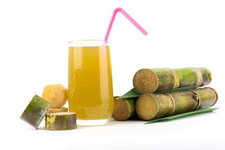 Fresh sugar cane juice in glass on white backgroundの写真素材