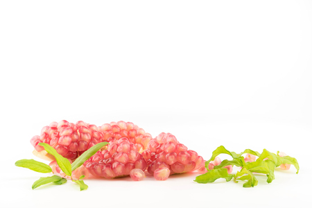 Ripe pomegranates with leaves isolated on a white background.の写真素材