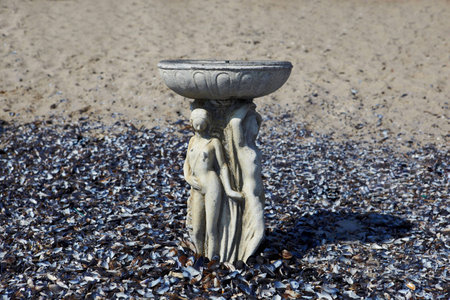 vintage cup on sand with shells on Odessa beachの写真素材