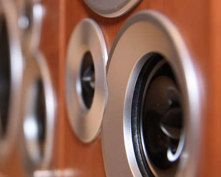 Black hi-fi speakers in wooden boxes in perspective view