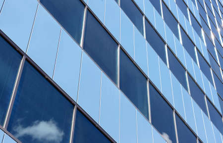 Sky and sun reflection in the windows of the office building