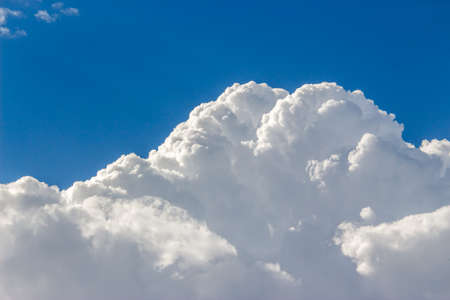 Blue sky with a lot of white puffy clouds.の写真素材