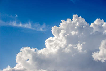 Blue sky with a lot of white puffy clouds.の写真素材