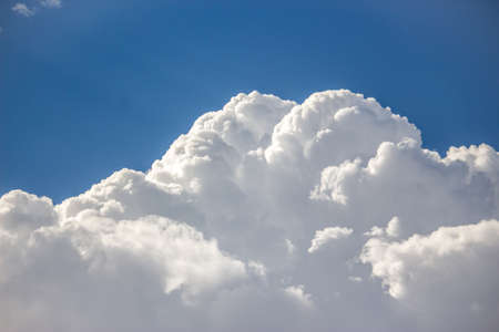 Blue sky with a lot of white puffy clouds.の写真素材