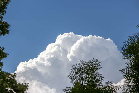 Blue sky with a lot of white puffy clouds.の写真素材