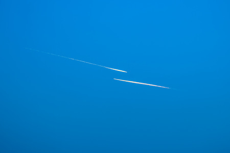 Two airplanes flying in blue sky.の写真素材