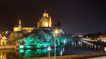 Night Evening Illuminated View Of The Metekhi Church And The Equestrian Statue Of King Vakhtang Gorgasali On The Metekhi Cliff In Old Historic District Of Tbilisi Georgia.の写真素材