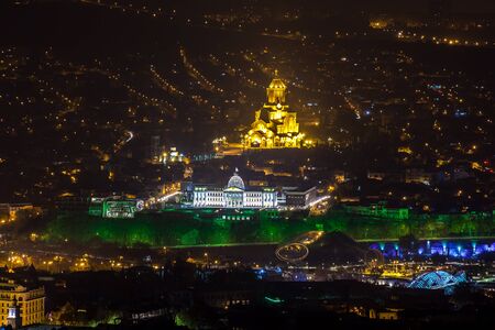 Tbilisi architecture in night. All main landmarks on one shot: illuminated Sameba cathedral,...