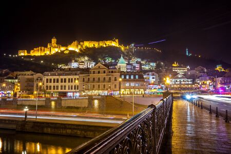 Aerial night view of Old Tbilisi, Georgia with Illuminated churches and Medieval fortress of ...