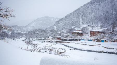 village covered with snow on the pass Rikota, Georgia.の写真素材
