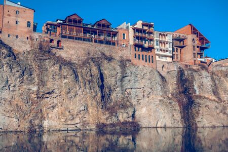 Houses on the edge of a cliff above the river Kura. Tbilisi, the historic city center.の写真素材