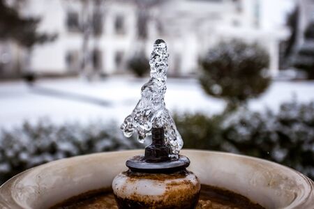 Close up water drops flowing from fontain.の写真素材