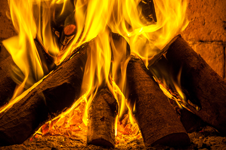 A fire burns in a fireplace.の写真素材