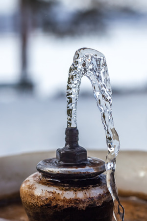 Close up water drops flowing from fountain.の写真素材