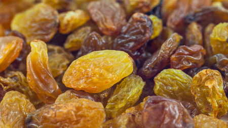 Dried grape raisins background, close up.