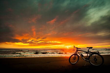Tourist bike on the coast of the sea at sunset time.の写真素材