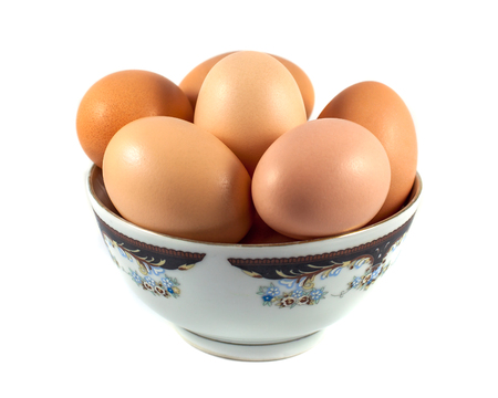 brown chicken eggs in a cup isolated on white.の写真素材
