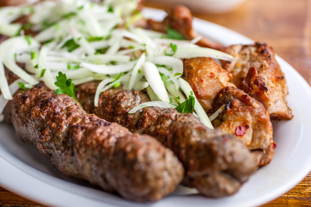 Traditional Georgian mtsvadi pork barbecue and Kebab with onion and parsley.の写真素材