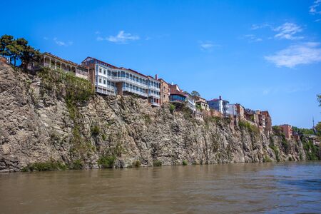 Metekhi church and Houses on the edge of a cliff above the river Kura. Tbilisi, the historic city center.の写真素材