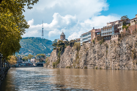 Metekhi church and Houses on the edge of a cliff above the river Kura. Tbilisi, the historic city center.の写真素材