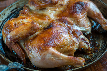 Roasted chicken on iron pan, homemade food.の写真素材