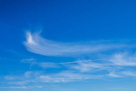 White clear clouds in the blue sky background.