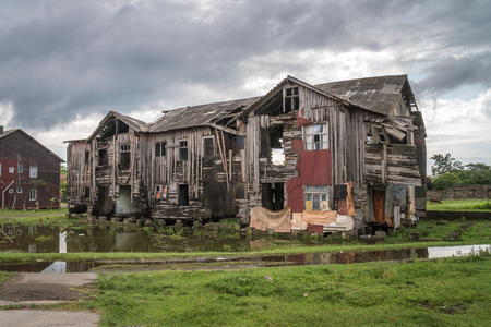Old broken wooden house on the outskirts of the city.の写真素材