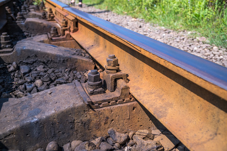 Close up detail of a rail track showing the steel track mounted.の写真素材