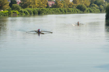 Teenage sportsmen in a boat, rowing on the river Rioni, Poti, Georgia.
